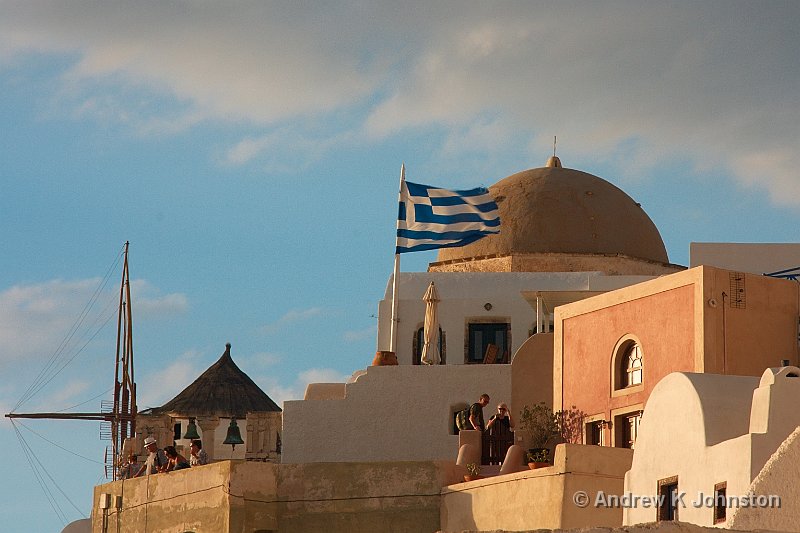1009_40D_9537.JPG - Church dome, windmill and Greek flag lit by sunset in Oia, Santorini. You wouldn't believe how many shots it took to get the flag at the right angle!